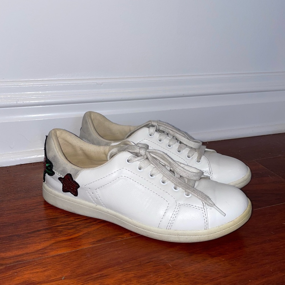White sneakers with flowers on the back